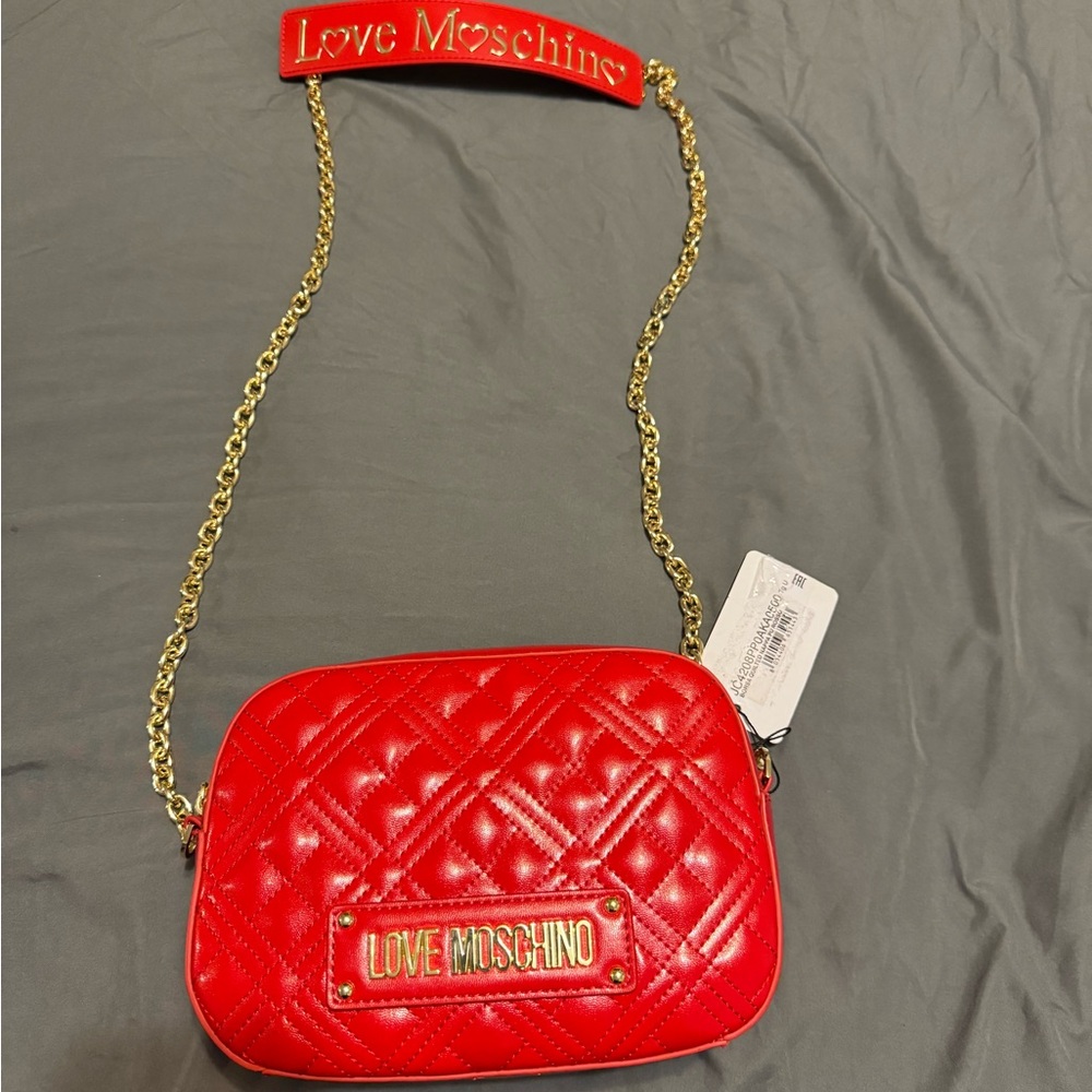 Beautiful red quilted leather Moschino shoulder bag with gold chain strap.